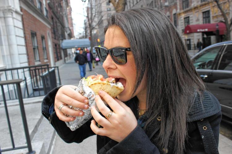 girl eating souvlaki