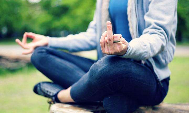 woman in meditation pose displaying rude gesture 20160316085141.jpg q75dx720y432u1r1ggc 