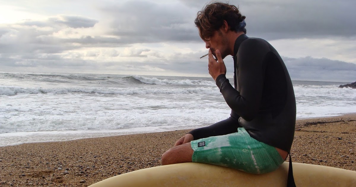 surfer smoking at the beach